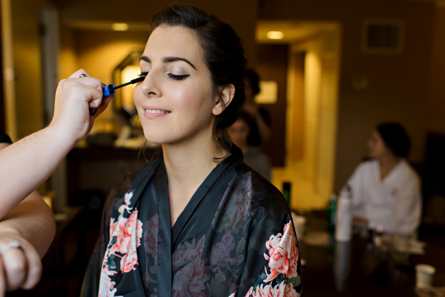 A bride getting her makeup done in the hotel suite in Philadelphia.